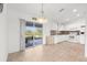 Bright dining area with a view and access to the screened in lanai and a view of the kitchen at 2665 Chipley Ave, North Port, FL 34286