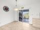 Bright dining area features tile floors, contemporary lighting, and access to the screened lanai at 2665 Chipley Ave, North Port, FL 34286
