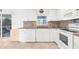 Bright kitchen with white cabinets, tile backsplash, and stainless steel appliances at 2665 Chipley Ave, North Port, FL 34286