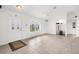 Bright living room with neutral tile floors, white walls, and archway, with a view of front yard at 2665 Chipley Ave, North Port, FL 34286