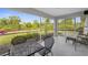 Screened-in patio with outdoor seating overlooks the lush backyard, perfect for relaxation and entertaining at 2665 Chipley Ave, North Port, FL 34286