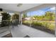 Screened-in patio with seating, offering outdoor space, and a view of the landscaped backyard at 2665 Chipley Ave, North Port, FL 34286