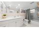 Well-lit bathroom with white vanity, tiled backsplash, and a shower with a gray curtain at 2909 Concord St, Sarasota, FL 34231