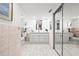 Bright bathroom featuring white tiling, a single sink vanity and a mirrored closet at 2909 Concord St, Sarasota, FL 34231