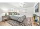 Bright bedroom with white walls, ceiling fan, two windows, and a decorative rug at 2909 Concord St, Sarasota, FL 34231