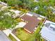 A single-Gathering home has verdant landscaping and mature shade trees on a quiet residential street at 2909 Concord St, Sarasota, FL 34231