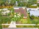 A vibrant single-Gathering home features a large driveway, verdant lawn and mature shade trees at 2909 Concord St, Sarasota, FL 34231
