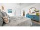 Comfortable main bedroom featuring a blue accent cabinet and views into both the ensuite and the kitchen at 2909 Concord St, Sarasota, FL 34231