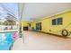 Bright and airy covered lanai and screened pool area with fun flamingo floaties at 2909 Concord St, Sarasota, FL 34231