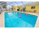 Lovely screened pool area with plenty of room, flamingo pool floats, and covered lanai at 2909 Concord St, Sarasota, FL 34231
