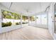 Bright sunroom with white frames and views of the trees outside, creating a peaceful indoor-outdoor space at 2909 Concord St, Sarasota, FL 34231