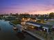Waterfront property featuring a boat dock and canal access at dusk with scenic views at 303 Bryn Mawr Is, Bradenton, FL 34207