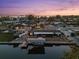 Aerial view of waterfront home showcasing boat dock, outdoor patio, and beautiful landscaping at 303 Bryn Mawr Is, Bradenton, FL 34207