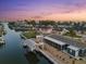 Waterfront home with boat dock, screened lanai, and manicured lawn at sunset at 303 Bryn Mawr Is, Bradenton, FL 34207