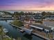 Aerial view of waterfront homes with boat docks and serene canal access at dusk at 303 Bryn Mawr Is, Bradenton, FL 34207
