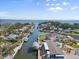 Beautiful aerial shot showcases a waterfront home with a boat dock and canal access at 303 Bryn Mawr Is, Bradenton, FL 34207