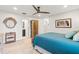 Coastal bedroom showcases a round mirror, wooden furniture, and calming blue bedding at 303 Bryn Mawr Is, Bradenton, FL 34207