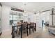 Bright dining area featuring a rustic wooden table, sliding barn door, and plenty of natural light at 303 Bryn Mawr Is, Bradenton, FL 34207