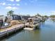 Waterfront property featuring a private boat dock and outdoor entertaining area with canal access at 303 Bryn Mawr Is, Bradenton, FL 34207