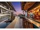 View of boat lift and outdoor bar at twilight from a dockside perspective at 303 Bryn Mawr Is, Bradenton, FL 34207