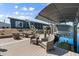 Waterfront property showcasing dock with boat lift, waterside patio, and home's screened-in porch at 303 Bryn Mawr Is, Bradenton, FL 34207