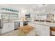 Stylish kitchen with stainless appliances, center island, and views to living area at 303 Bryn Mawr Is, Bradenton, FL 34207