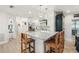 Bright kitchen featuring a marble-topped island with wooden stools and stainless steel appliances at 303 Bryn Mawr Is, Bradenton, FL 34207