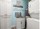 Laundry room with tiled backsplash, washer, dryer, and 'Wash and Dry' sign at 303 Bryn Mawr Is, Bradenton, FL 34207