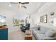 Comfortable coastal-style living room with shiplap walls, waterfront views, and ceiling fan at 303 Bryn Mawr Is, Bradenton, FL 34207