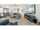 Cozy living room featuring a striped sofa, nautical decor and a modern fireplace at 303 Bryn Mawr Is, Bradenton, FL 34207