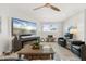 Comfortable living room offering leather seating, a modern fireplace and a ceiling fan at 303 Bryn Mawr Is, Bradenton, FL 34207