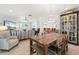 Spacious open living area with a rustic dining table and comfortable seating at 303 Bryn Mawr Is, Bradenton, FL 34207