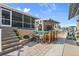 Outdoor bar area and patio overlooking the water, complete with bar stools and string lights at 303 Bryn Mawr Is, Bradenton, FL 34207