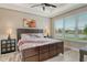 Serene bedroom with plush bedding, natural light, and picturesque window views for a peaceful retreat at 3115 Duomo Ct, Bradenton, FL 34211