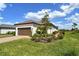 Lovely home showcasing a well-maintained exterior, a tile roof, and a manicured lawn with mature landscaping at 3115 Duomo Ct, Bradenton, FL 34211