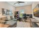 Spacious home office provides a comfortable couch, workspace, and storage for a productive work environment at 3115 Duomo Ct, Bradenton, FL 34211