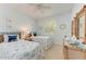 Charming bedroom with twin beds, coastal decor, and natural light at 322 Langholm Dr, Venice, FL 34293