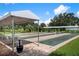 Outdoor bocce ball courts shaded by canopies, offering a leisurely recreational activity in a serene setting at 322 Langholm Dr, Venice, FL 34293