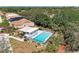 Beautiful community pool area with ample seating, pergola, and well-manicured landscaping, perfect for outdoor enjoyment at 322 Langholm Dr, Venice, FL 34293