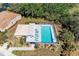 Aerial view of a stunning community pool featuring lounge chairs, pristine landscaping, and a tranquil setting for relaxation at 322 Langholm Dr, Venice, FL 34293