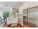 Updated kitchen offers white cabinets, stainless steel appliances including a refrigerator with water dispenser at 322 Langholm Dr, Venice, FL 34293