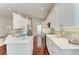 Modern kitchen featuring white cabinets, quartz countertops, stainless steel appliances, and stylish backsplash at 322 Langholm Dr, Venice, FL 34293