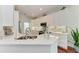 Bright, modern kitchen featuring white cabinetry, quartz countertops, stainless steel appliances, and modern fixtures at 322 Langholm Dr, Venice, FL 34293