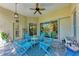 Beautiful lanai with a ceiling fan and seating area featuring Adirondack chairs and a table at 322 Langholm Dr, Venice, FL 34293