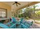Relaxing screened-in lanai with ceiling fan and Adirondack chairs for outdoor seating and entertainment at 322 Langholm Dr, Venice, FL 34293