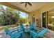 Beautiful lanai with a ceiling fan and seating area featuring Adirondack chairs and a table at 322 Langholm Dr, Venice, FL 34293