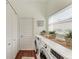 Functional laundry room with modern appliances and decor at 322 Langholm Dr, Venice, FL 34293