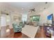 Spacious living room with hardwood floors, comfortable seating, and access to the kitchen and dining area at 322 Langholm Dr, Venice, FL 34293