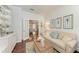 Inviting living room featuring a comfortable sofa, stylish decor, and view to the kitchen at 322 Langholm Dr, Venice, FL 34293