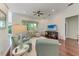 Bright living room featuring hardwood floors, comfortable seating and a ceiling fan at 322 Langholm Dr, Venice, FL 34293